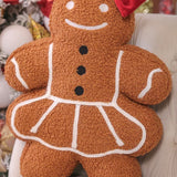 Gingerbread girl pillow with festive details, soft and cozy holiday home accent.