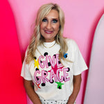 Ivory Comfort Colors tee with hot pink Give Grace lettering, polka dots, and colorful stars