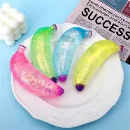Glitter banana squishy stress toy with sparkling sensory texture.