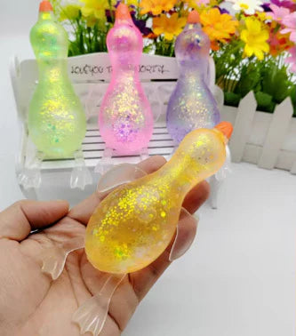 Glitter-filled translucent duck squishy toy in assorted colors.