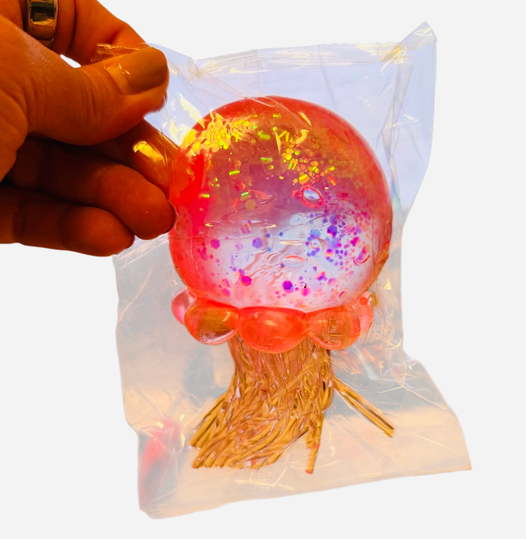 Glitter jellyfish squishy stress toy in assorted colors.