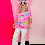 Pink oversized sequin top with birthday treats and colorful candy graphics.