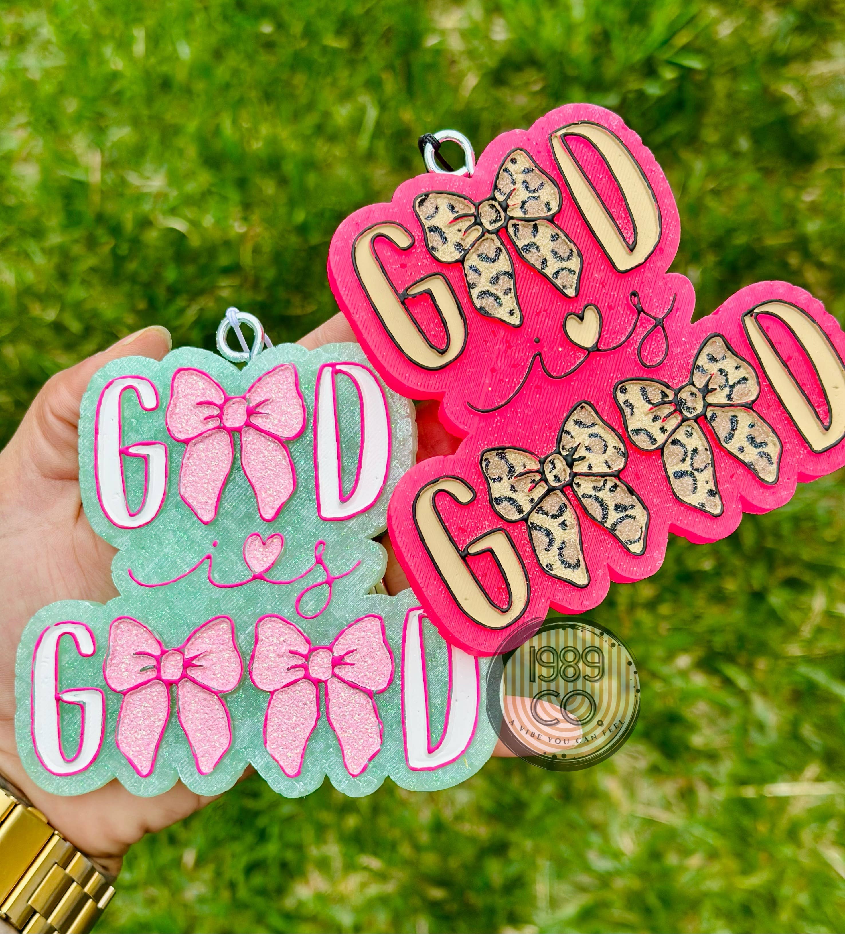 Pink God Is Good car freshie with leopard print bows and hook for hanging.