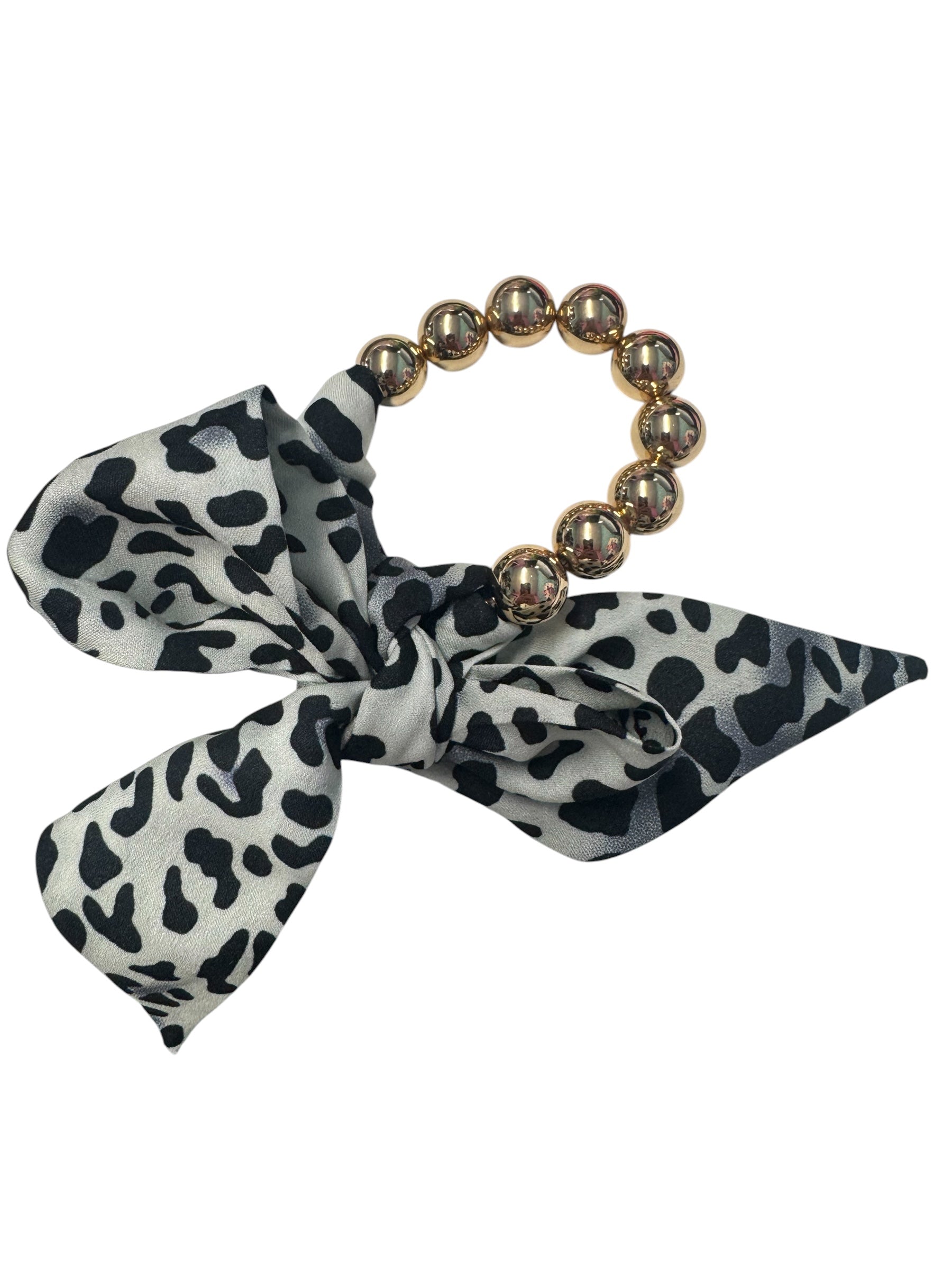 Oversized gold bead stretch bracelet with black and cream animal print scarf.