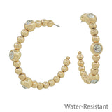 Water resistant gold beaded hoop dangle earrings with crystal accents, 2-inch size.