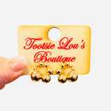 Gold beaded hoop earrings with clustered bead detailing.