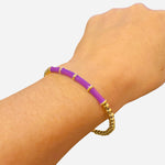 Waterproof gold bangle with purple cylindrical accents and round bead design for elegant modern style.