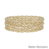 Set of five gold beaded textured stretch bracelets, water resistant and stylish for stacking.