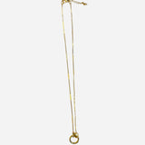 Gold charm necklace with textured chain and front-facing circular clasp
