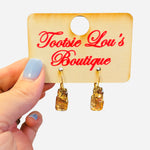 Gold hoop earrings with rectangular and round gold gemstone drops.