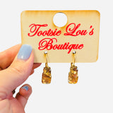 Gold hoop earrings with rectangular and round gold gemstone drops.