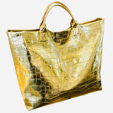 Gold glossy crocodile embossed tote bag with spacious interior and hook-and-loop closure.
