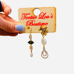 Gold mismatch earrings with crystal chain, pearl drop, and sunburst geometric details