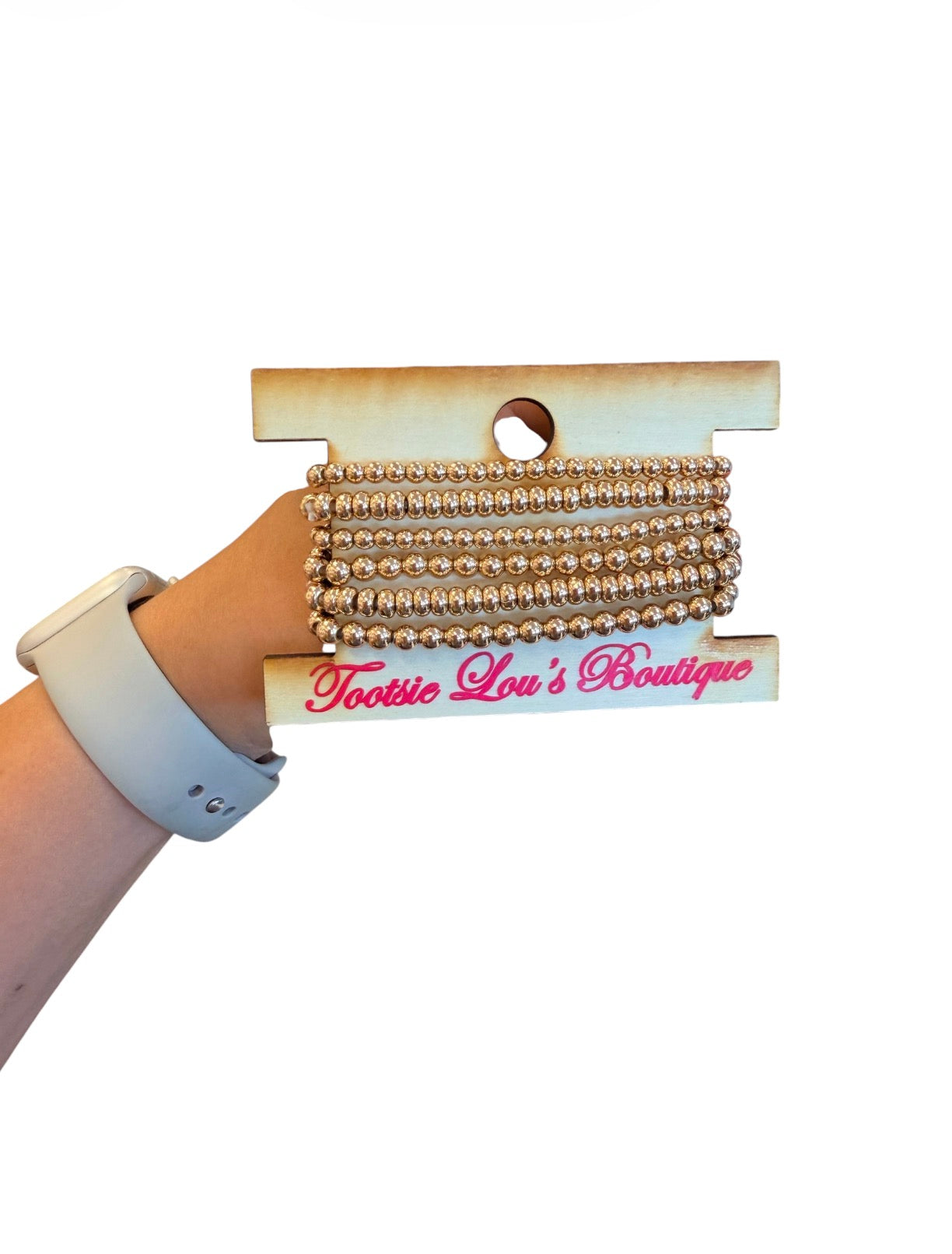 Six-piece water-resistant gold bead bracelet stack with round and rondelle beads.