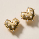 Matte heart stud earrings adorned with faux pearls for a bold, playful look.