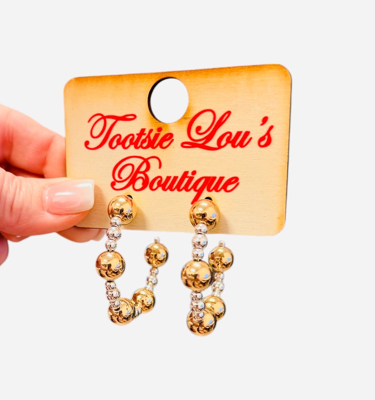 Gold and silver beaded hoop earrings with mixed metal bead sizes.