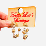 Gold and silver beaded hoop earrings with mixed metal bead sizes.