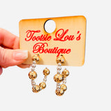 Gold and silver beaded hoop earrings with mixed metal bead sizes.