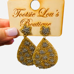 Teardrop earrings with gold and silver beadwork and star-shaped beaded stud.