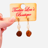 Gold teardrop stud earrings with neutral and amber stone drop.