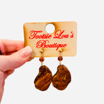 Gold stud earrings with tortoise shell drop