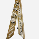 Golden twilly scarf with floral illustrations and butterfly details.