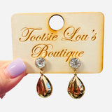 Water-resistant gold teardrop earrings with crystal studs and reflective glossy teardrop charm.