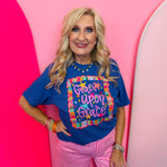 Royal blue Grace Upon Grace graphic tee with colorful stars and bows.