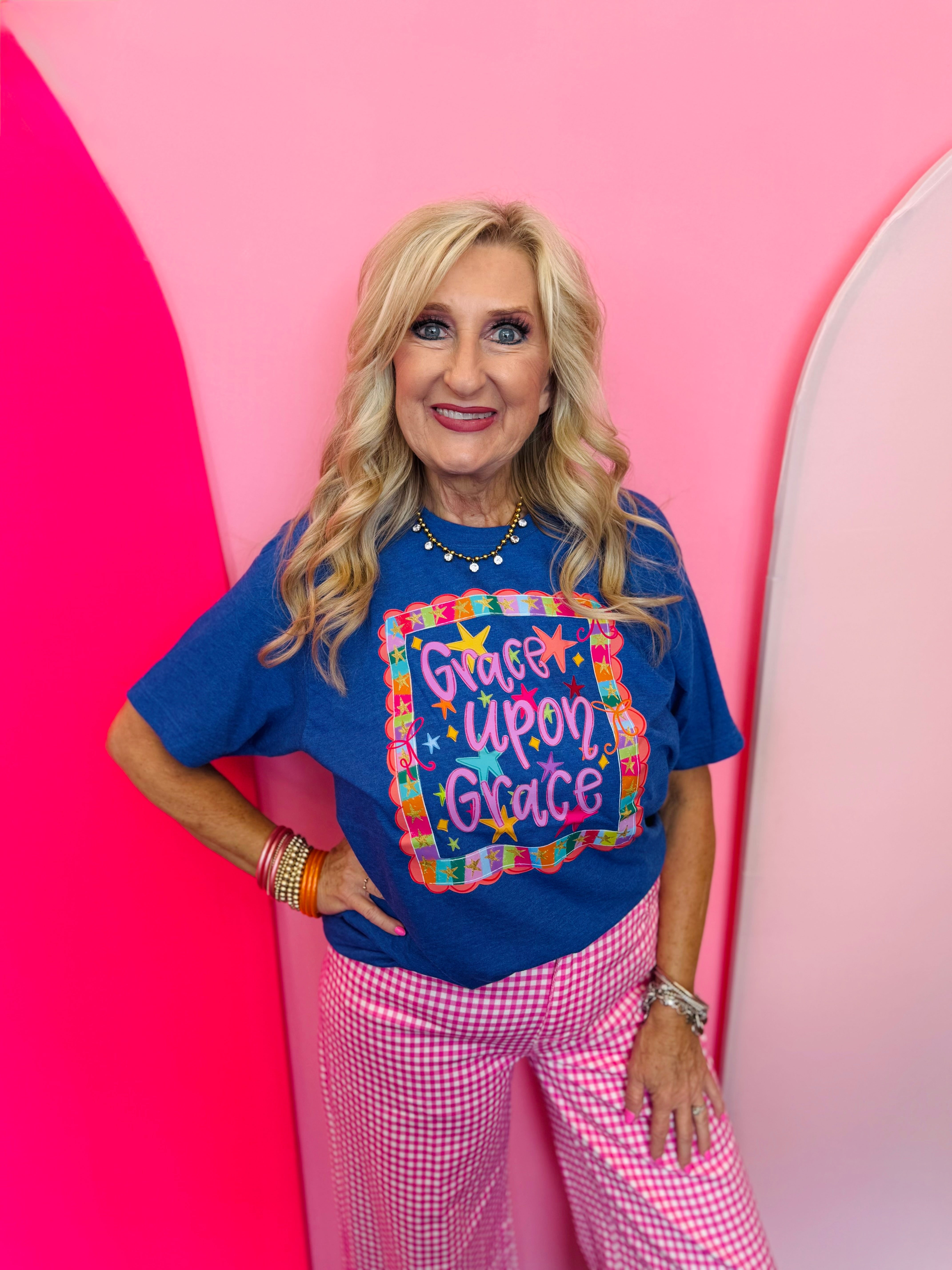 Royal blue Grace Upon Grace graphic tee with colorful stars and bows.