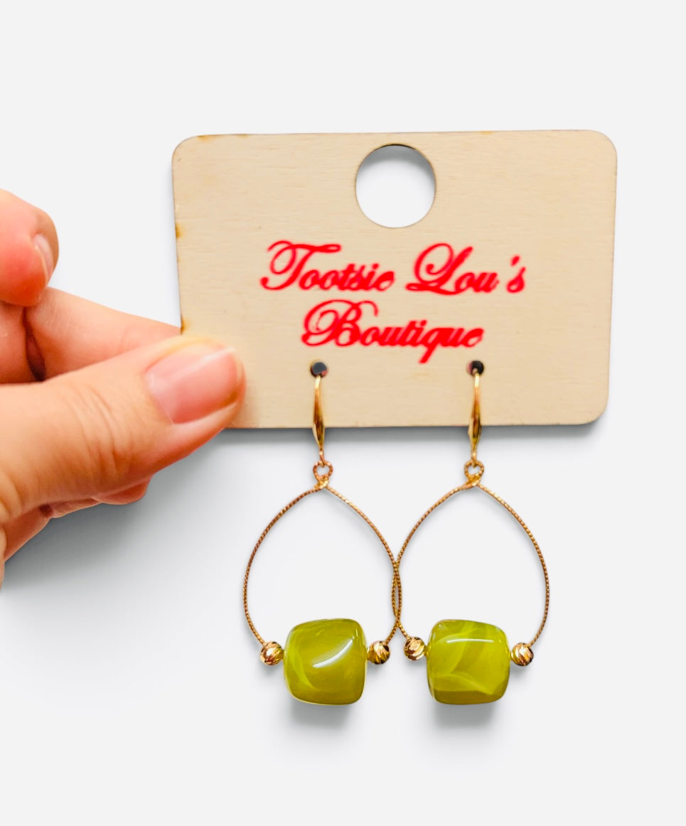 Green marbled bead earrings with gold-tone teardrop frames and gold accents.