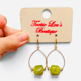 Green marbled bead earrings with gold-tone teardrop frames and gold accents.