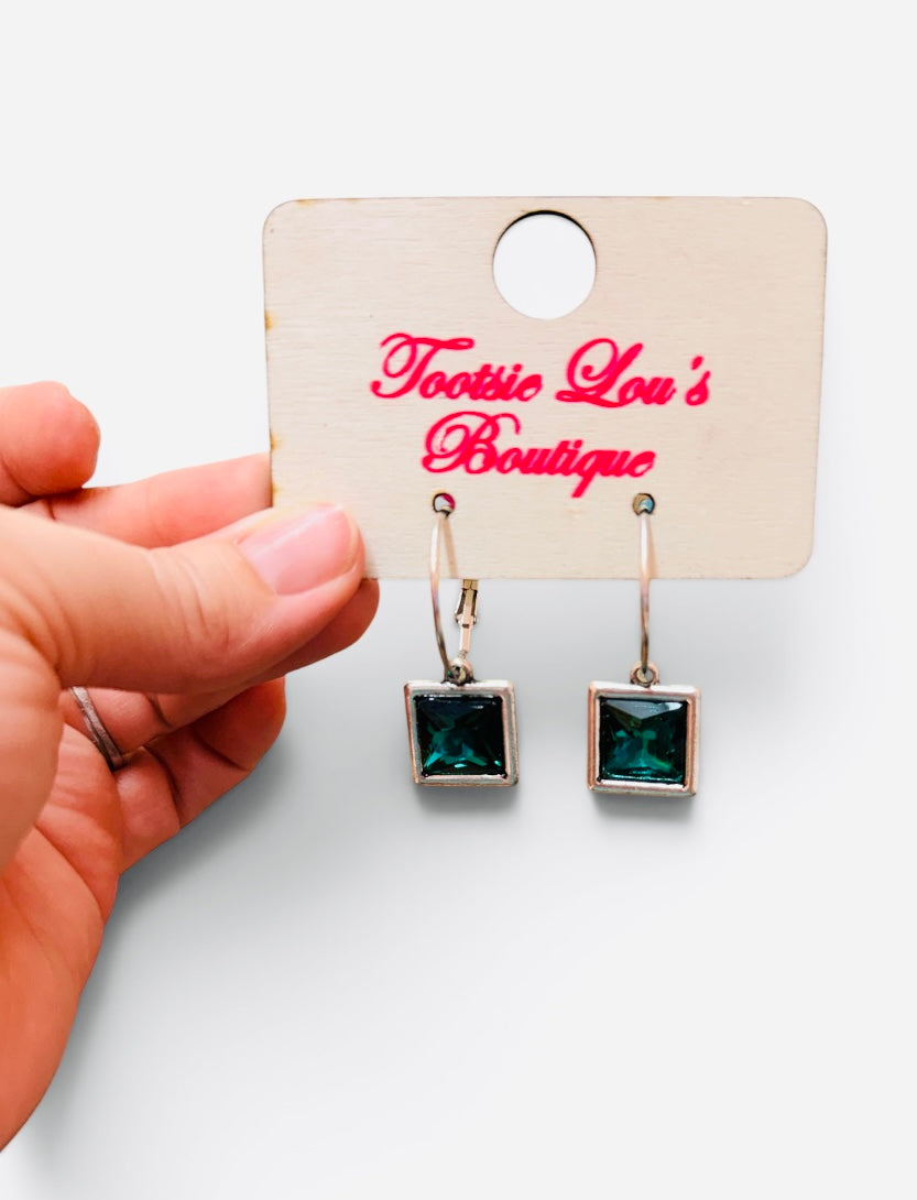 Gold-tone hoops with faceted green square crystal drop earrings.