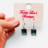 Gold-tone hoops with faceted green square crystal drop earrings.