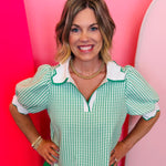 Green gingham puff sleeve top with scallop trim and split V-neck.