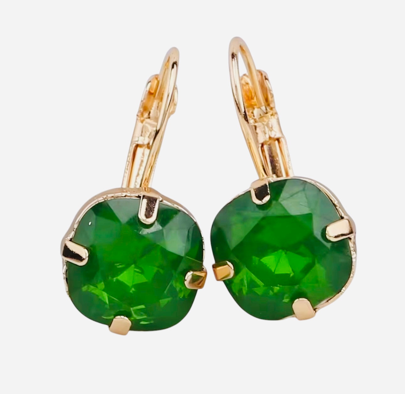 Gold tone drop earrings with faceted green gemstone and fishhook ear wire.