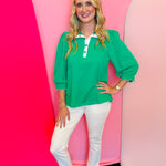Green puff sleeve top with scalloped trim and contrast neckline