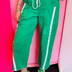 Kelly green cropped pants with white side stripes and drawstring waist.