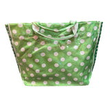 Green tote bag with white polka dots, sturdy handles, interior pockets, and Velcro closure.