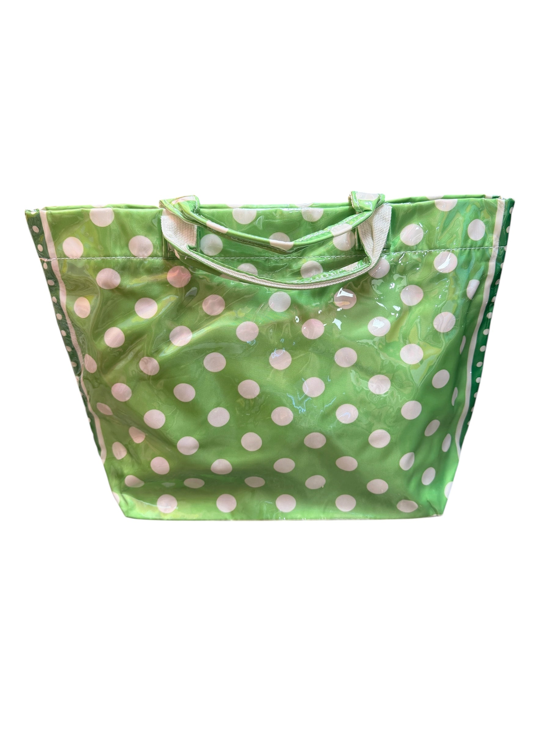 Green tote bag with white polka dots, sturdy handles, interior pockets, and Velcro closure.
