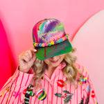 Tie-dye trucker hat with gold “Gumdrops & Gucci” embroidery, rainbow beaded brim, and mesh back.