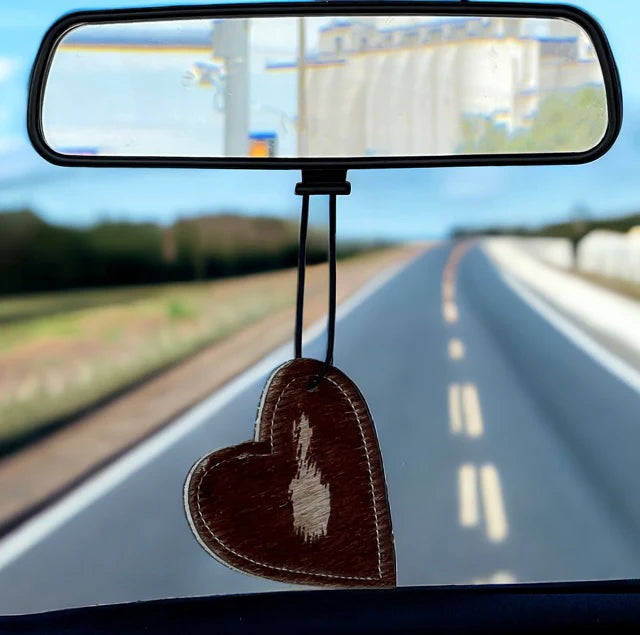 Heart-shaped leather and cowhide car freshener charm, handcrafted, reusable with scented oil mists, ideal for car, home, or camper.