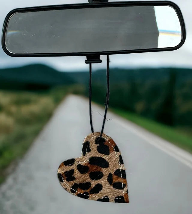 Heart-shaped leather and cowhide car freshener charm, handcrafted, reusable with scented oil mists, ideal for car, home, or camper.