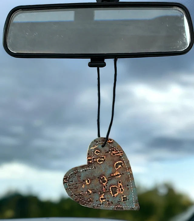 Heart-shaped leather and cowhide car freshener charm, handcrafted, reusable with scented oil mists, ideal for car, home, or camper.