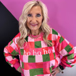 Fuzzy HO HO HO sweatshirt with pink, red, and green checkered holiday print.