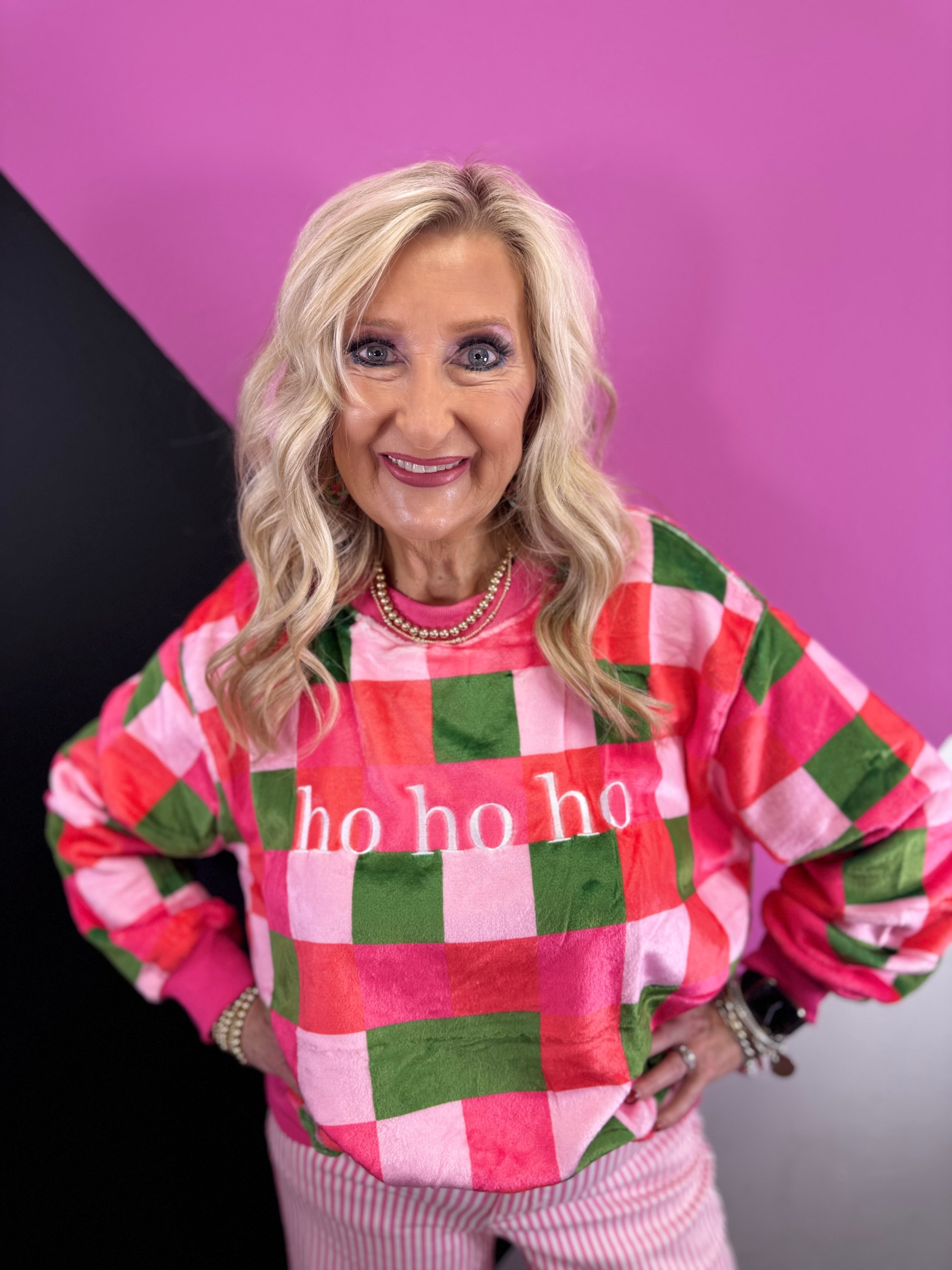 Fuzzy HO HO HO sweatshirt with pink, red, and green checkered holiday print.