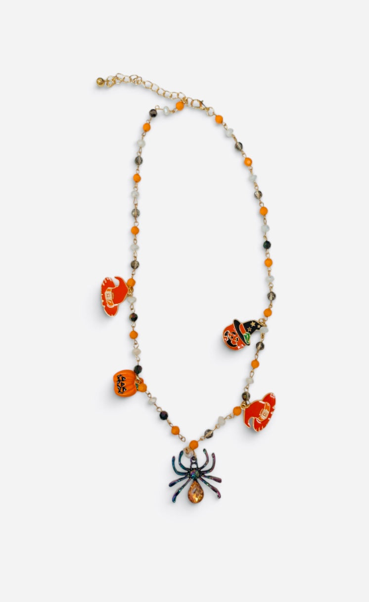 Halloween charm necklace with orange black beads, pumpkins, witch, jack-o'-lantern, and sparkling spider.