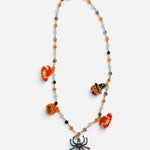 Halloween charm necklace with orange black beads, pumpkins, witch, jack-o'-lantern, and sparkling spider.