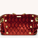 Small Hammitt Daniel crossbody clutch in cherrywood leather with orange Italian velvet accents and brushed gold hardware.