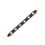 Hammitt black pebbled leather handbag strap with shiny gold grommet detailing, measuring 21 inches long.