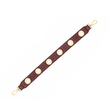 Hammitt cherrywood oxblood red pebbled leather handbag strap with brushed gold grommet detailing.